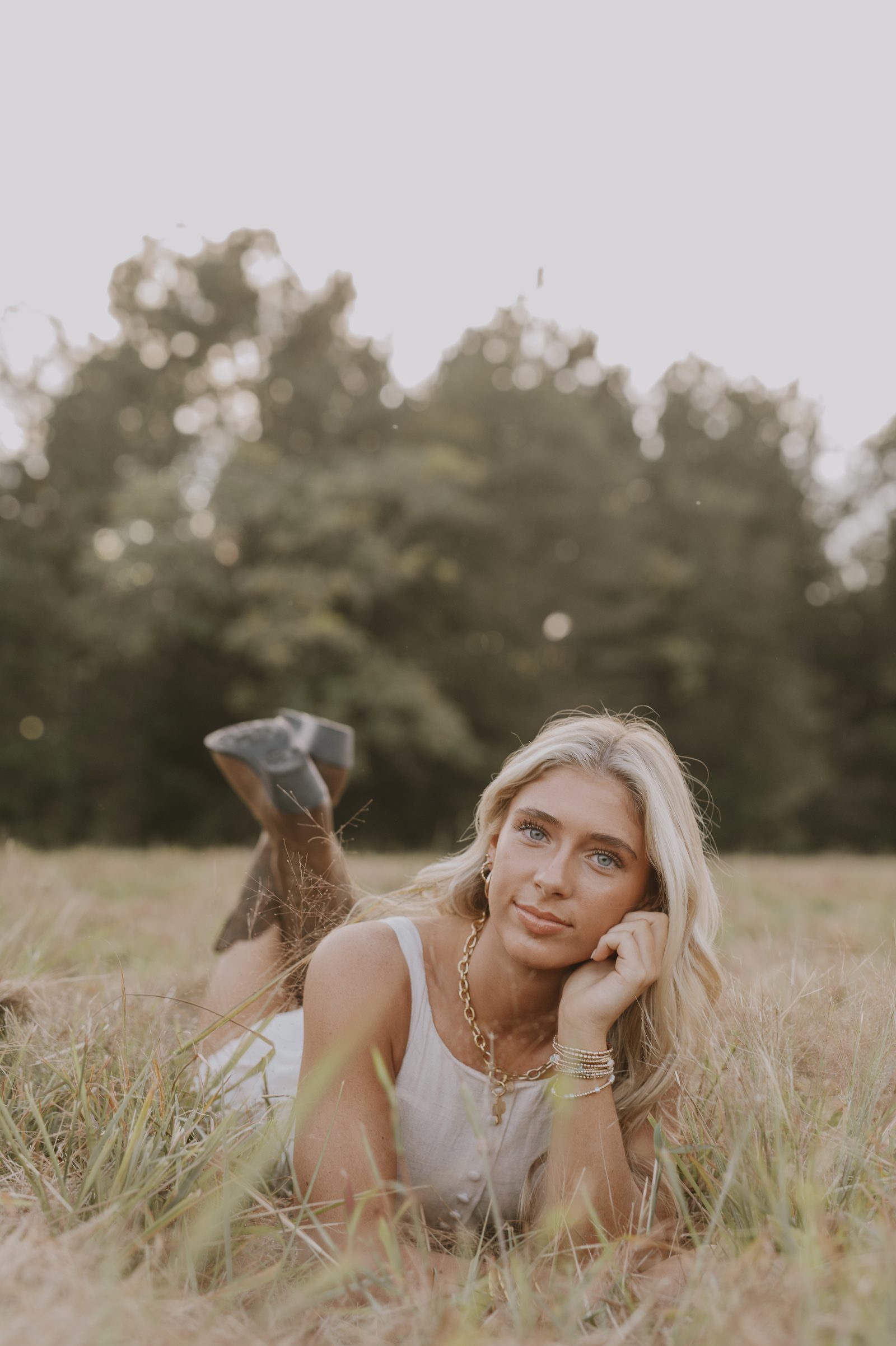 Lifestyle portrait with golden retriever in tall grass