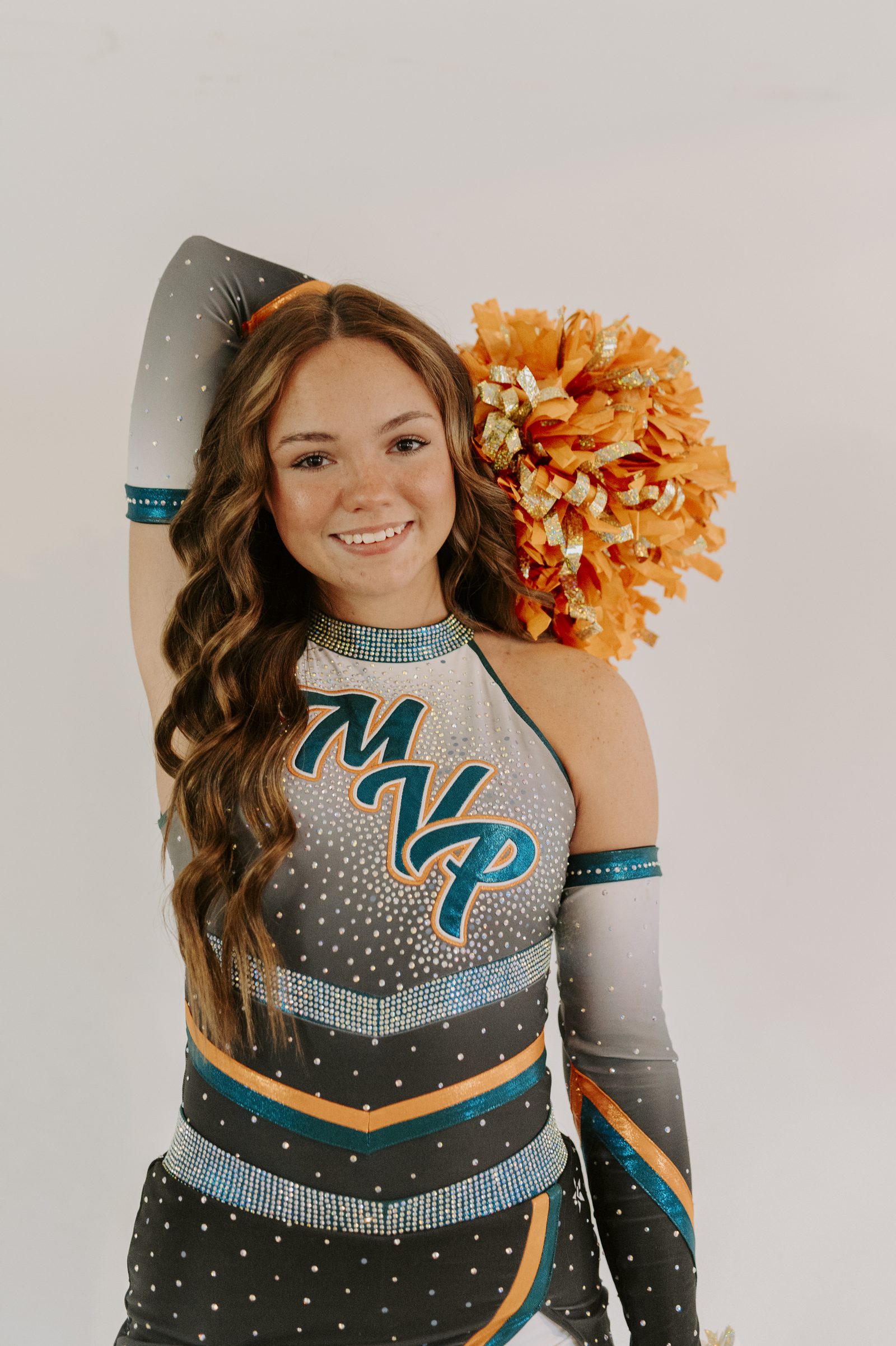 Senior cheerleader portrait holding pompoms